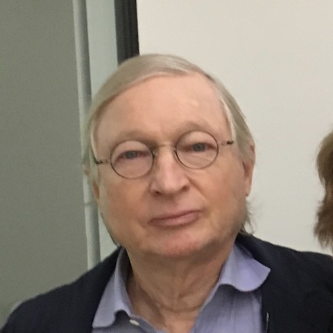 White male wearing thin rim glasses and shirt and tie.
